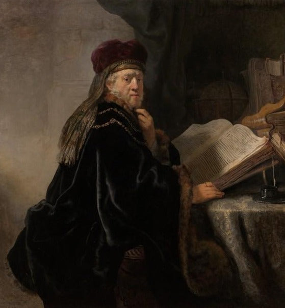 Un érudit assis à un bureau - Rembrandt van Rijn