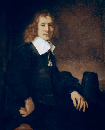 Un jeune homme assis à une table (peut-être Govaert Flinck) - Rembrandt van Rijn